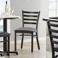 Lancaster Table & Seating Distressed Copper Finish Ladder Back Chair With 2 1/2" Dark Gray Vinyl Padded Seat