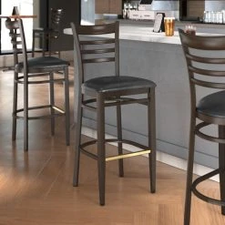 LT&S Spartan Series Lancaster Table & Seating Spartan Series Bar Height Metal Ladder Back Chair With Walnut Wood Grain Finish And Black Vinyl Seat