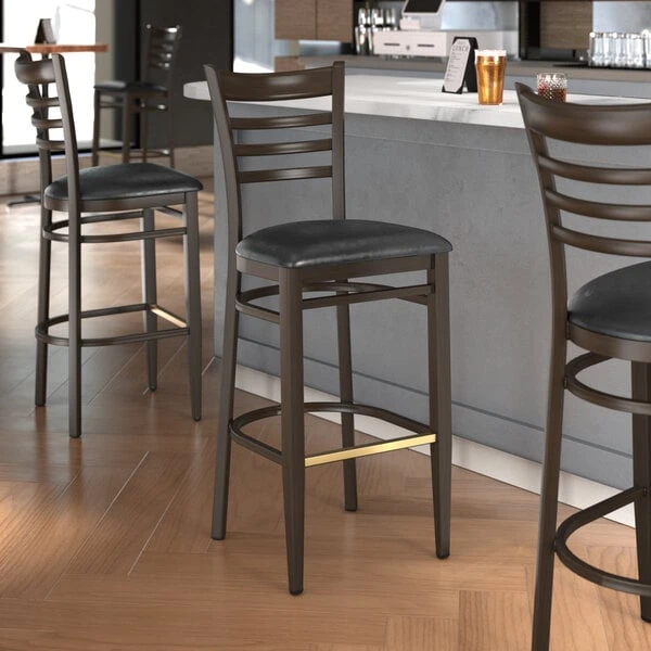 LT&S Spartan Series Lancaster Table & Seating Spartan Series Bar Height Metal Ladder Back Chair With Walnut Wood Grain Finish And Black Vinyl Seat 3 LT&S Spartan Series Lancaster Table & Seating Spartan Series Bar Height Metal Ladder Back Chair With Walnut Wood Grain Finish And Black Vinyl Seat