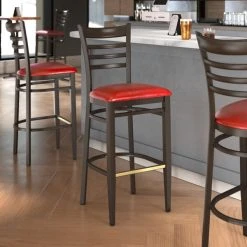 LT&S Spartan Series Lancaster Table & Seating Spartan Series Bar Height Metal Ladder Back Chair With Walnut Wood Grain Finish And Red Vinyl Seat