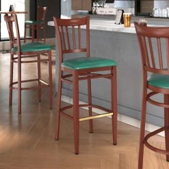 LT&S Spartan Series Lancaster Table & Seating Spartan Series Bar Height Metal Slat Back Chair With Mahogany Wood Grain Finish And Green Vinyl Seat