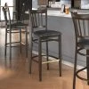 LT&S Spartan Series Lancaster Table & Seating Spartan Series Bar Height Metal Slat Back Chair With Walnut Wood Grain Finish And Black Vinyl Seat