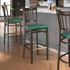 LT&S Spartan Series Lancaster Table & Seating Spartan Series Bar Height Metal Slat Back Chair With Walnut Wood Grain Finish And Green Vinyl Seat